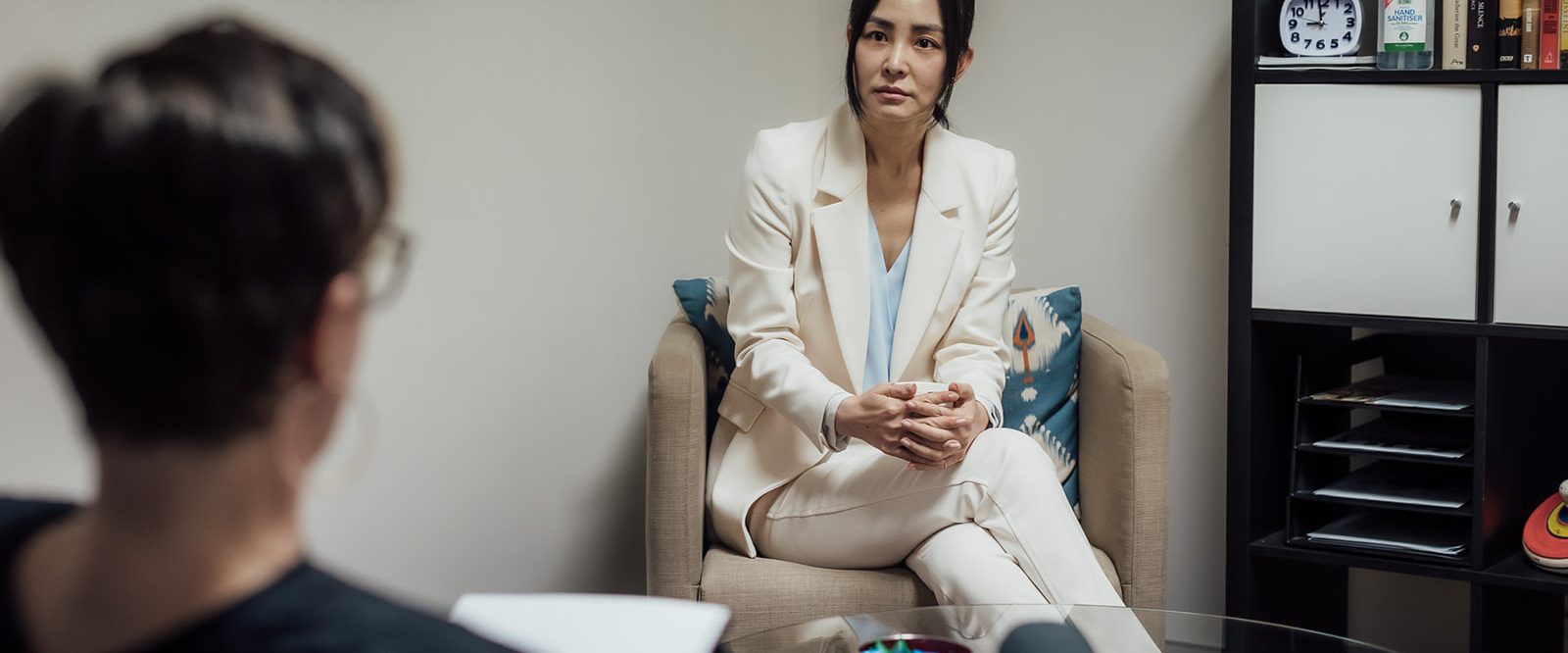 A young woman looking sad in a counselling session.